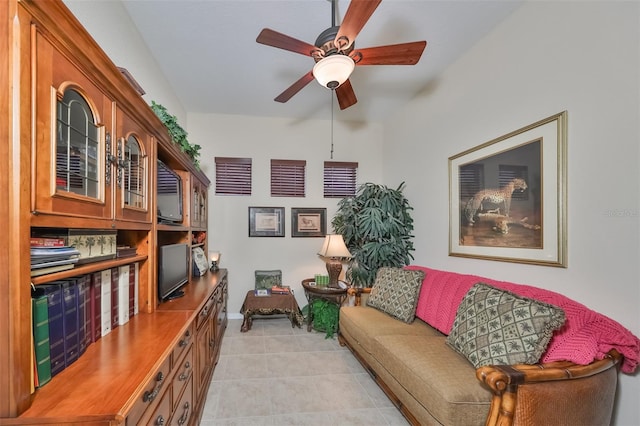 sitting room featuring ceiling fan and light tile flooring