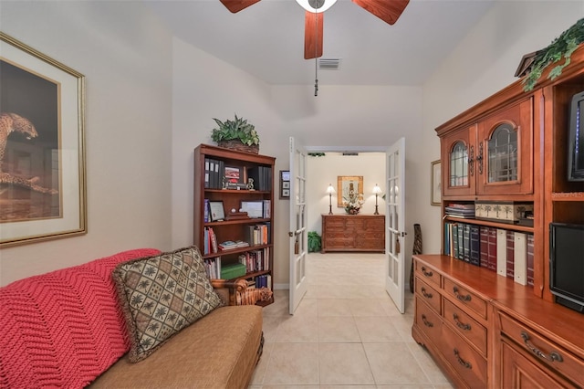 sitting room with ceiling fan and light tile floors