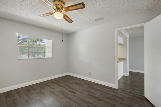 unfurnished room with dark hardwood / wood-style flooring, ceiling fan, and a textured ceiling