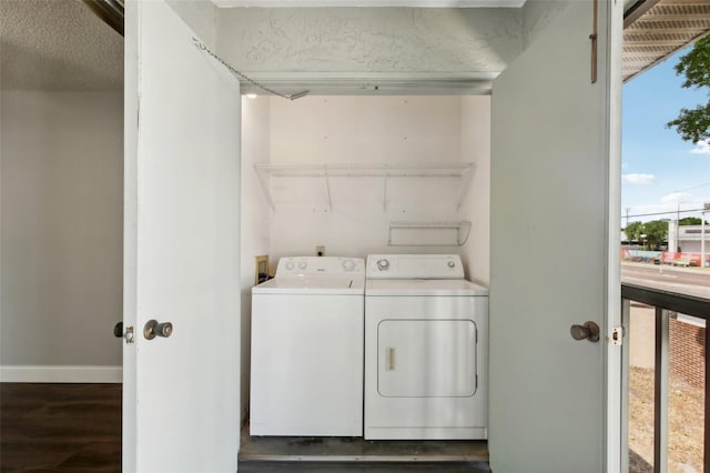 laundry area with dark wood-type flooring, separate washer and dryer, and hookup for a washing machine