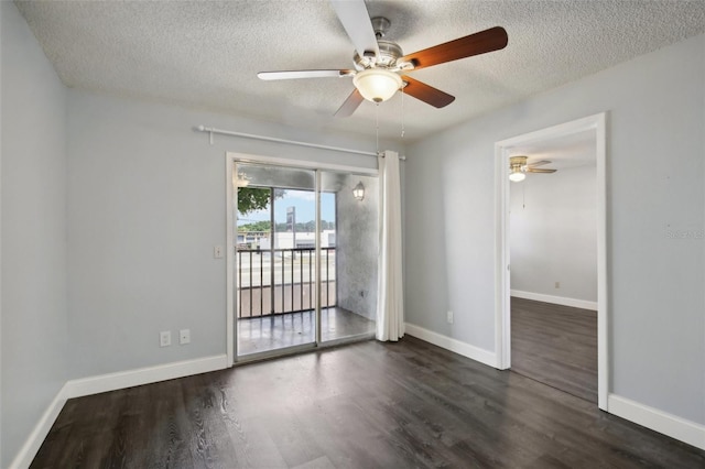 spare room featuring dark hardwood / wood-style flooring, ceiling fan, and a textured ceiling