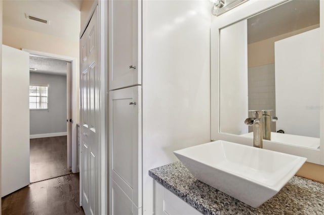 bathroom featuring hardwood / wood-style flooring and vanity