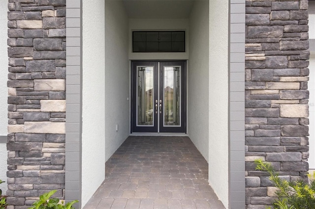 doorway to property with french doors and stucco siding