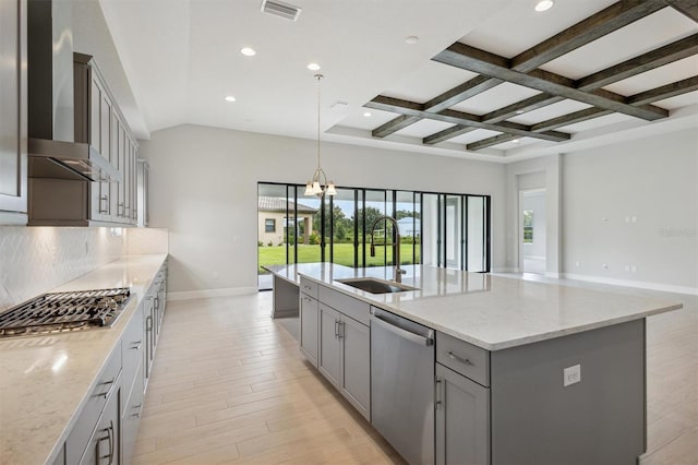 kitchen featuring wall chimney range hood, coffered ceiling, beamed ceiling, sink, and backsplash