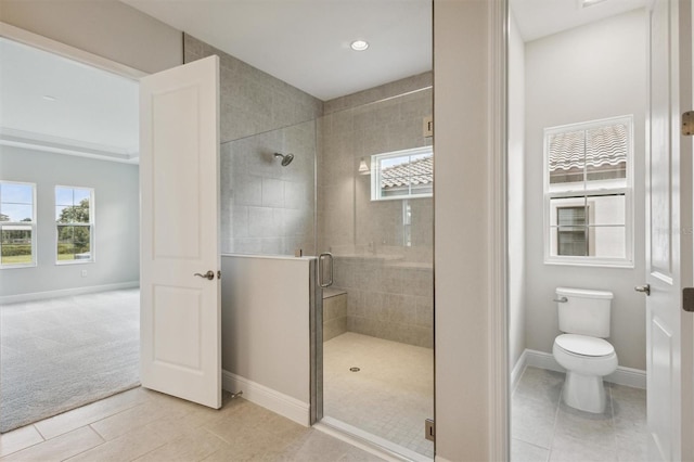 bathroom featuring walk in shower, tile patterned floors, and toilet