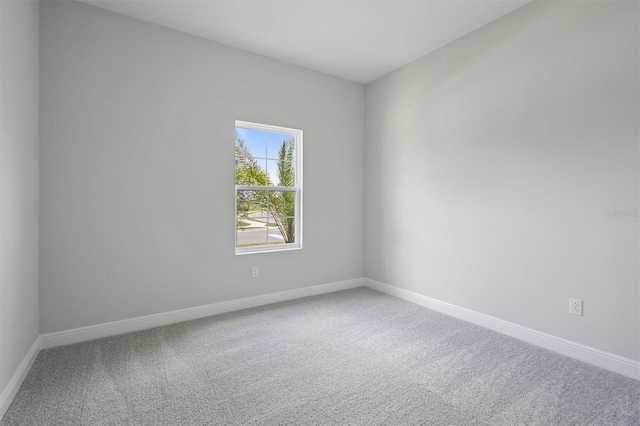 empty room with carpet flooring and baseboards