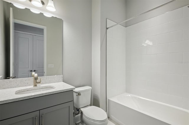 full bathroom featuring toilet, tiled shower / bath combo, and vanity