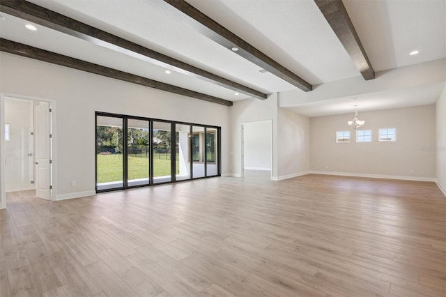 unfurnished living room with beamed ceiling, a notable chandelier, and light hardwood / wood-style floors