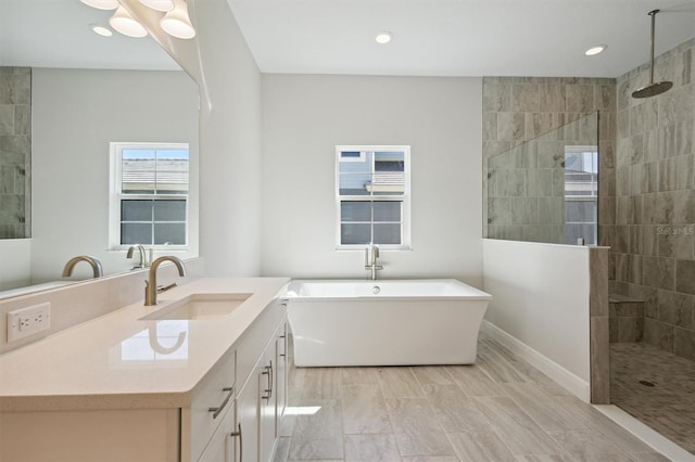 bathroom with vanity and independent shower and bath