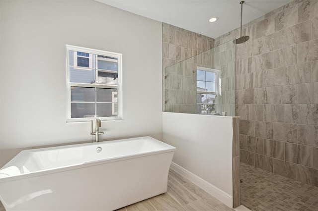 bathroom featuring shower with separate bathtub and hardwood / wood-style flooring