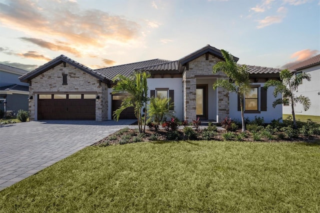 view of front facade with a lawn and a garage