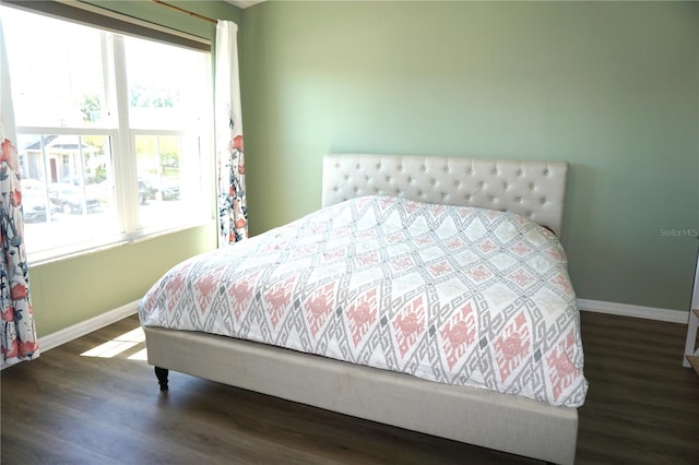 bedroom with dark wood-type flooring