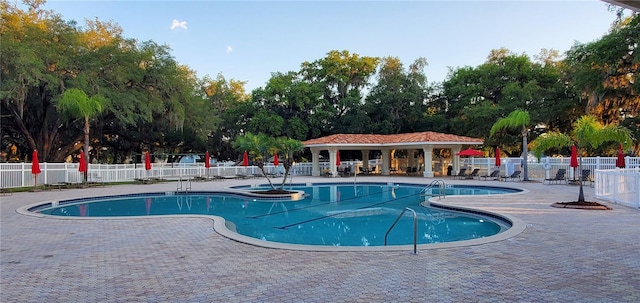 view of pool featuring a patio area and a hot tub