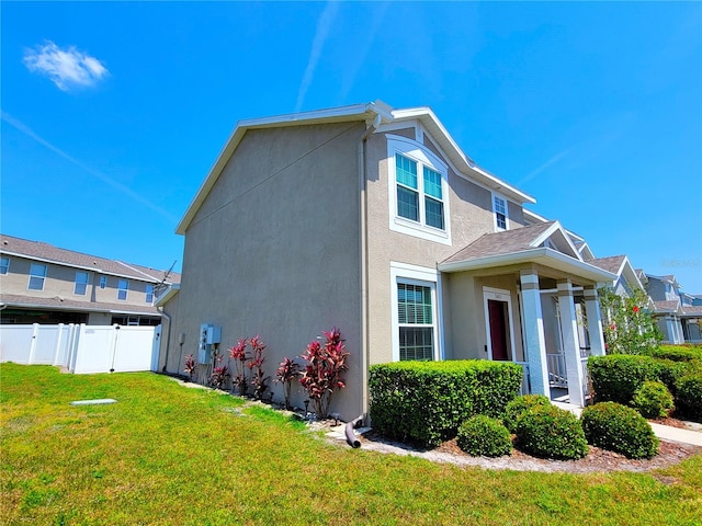 view of side of home with a lawn