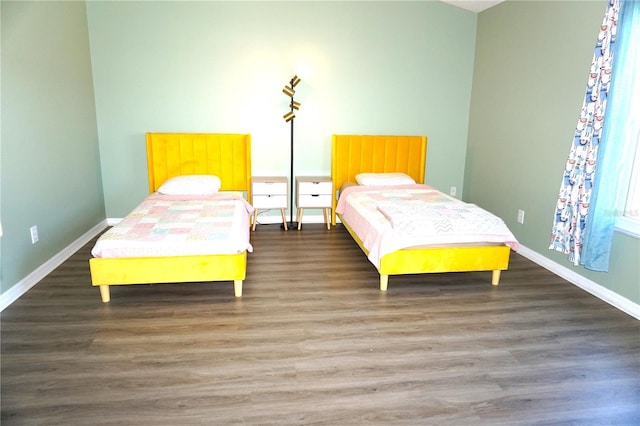 bedroom with dark wood-type flooring