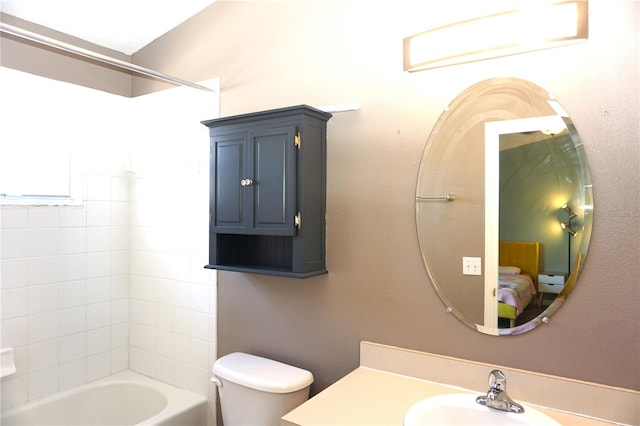 full bathroom featuring toilet, vanity, and tiled shower / bath