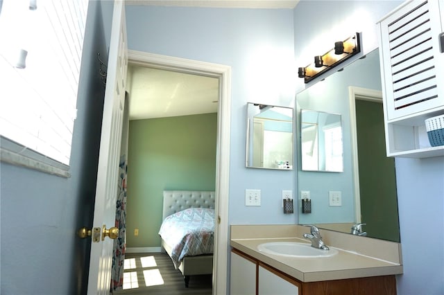 bathroom with hardwood / wood-style floors, plenty of natural light, and vanity