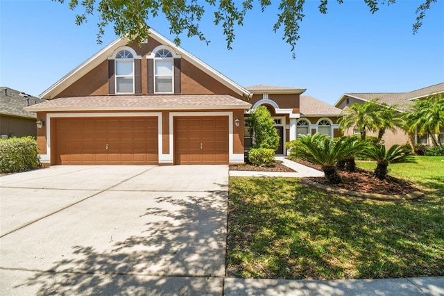 view of front of property with a garage and a front yard