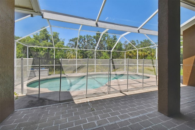 view of pool with a lanai and a patio