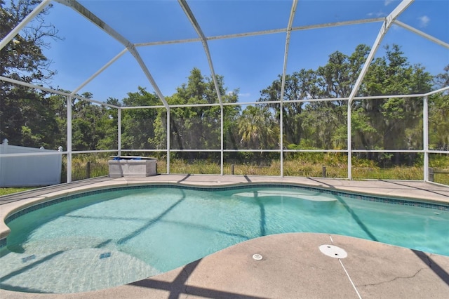 view of pool featuring glass enclosure