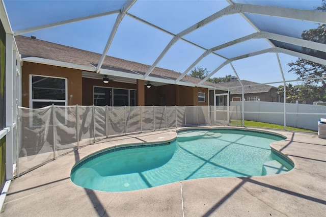 view of pool featuring a patio area, ceiling fan, and glass enclosure