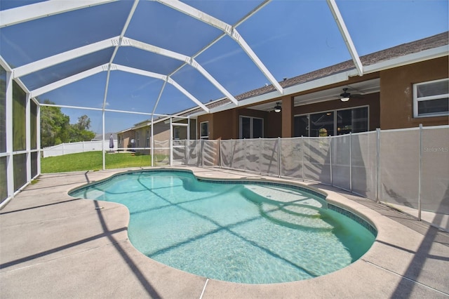 view of pool with ceiling fan and glass enclosure