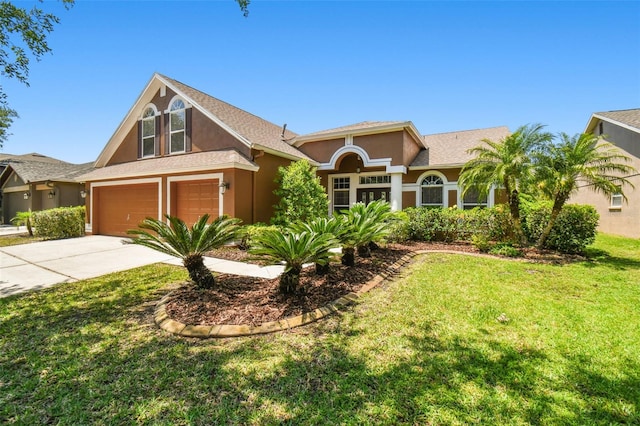 view of front of home with a front lawn and a garage