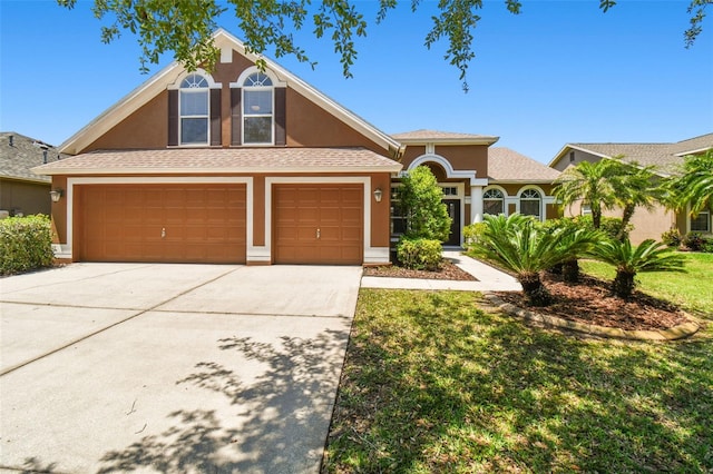 view of front of home with a garage and a front yard