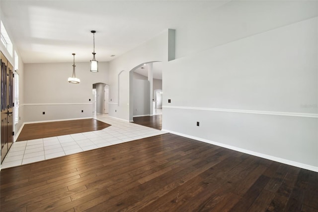 foyer entrance featuring tile floors and high vaulted ceiling