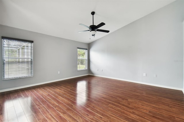 spare room featuring ceiling fan, lofted ceiling, and dark hardwood / wood-style flooring