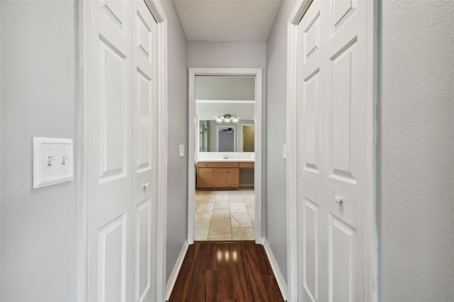 corridor with dark hardwood / wood-style floors