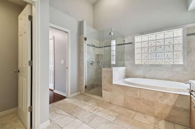 bathroom featuring hardwood / wood-style floors, vanity, and separate shower and tub