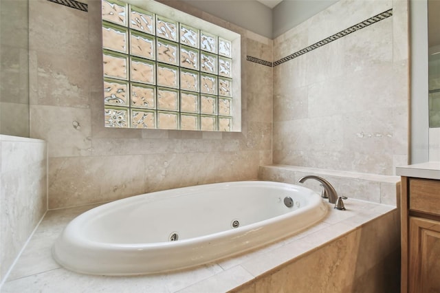 bathroom featuring a relaxing tiled bath and vanity