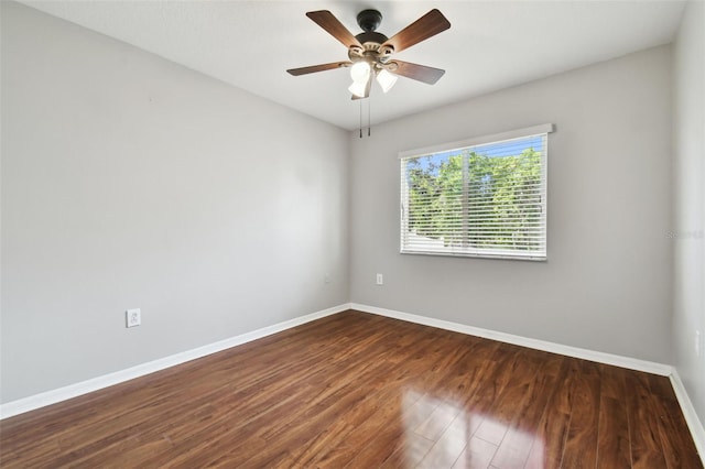 spare room with ceiling fan and dark hardwood / wood-style flooring