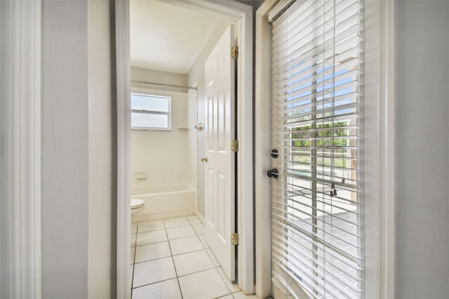 interior space featuring tile floors and toilet