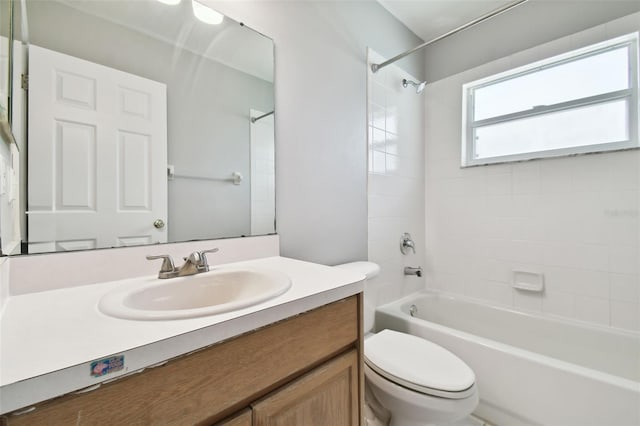 full bathroom with vanity, tiled shower / bath combo, and toilet