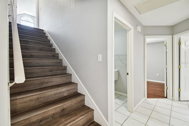 stairway featuring light tile floors