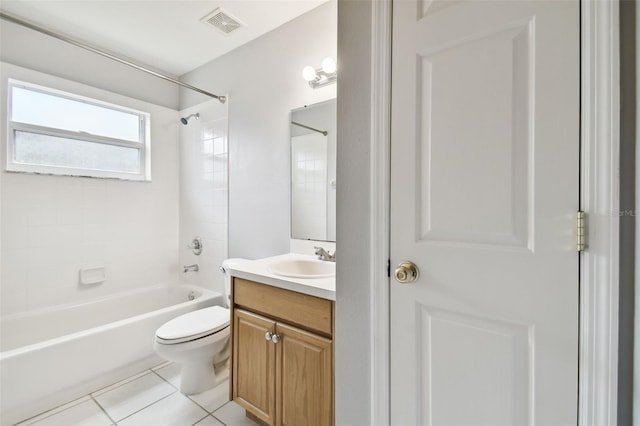 full bathroom with tiled shower / bath combo, toilet, tile floors, and vanity