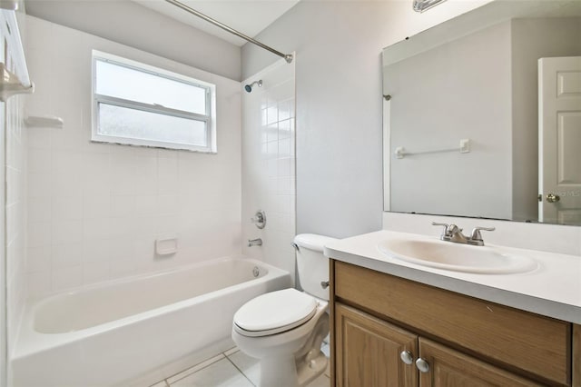 full bathroom with tile flooring, vanity with extensive cabinet space, tiled shower / bath combo, and toilet