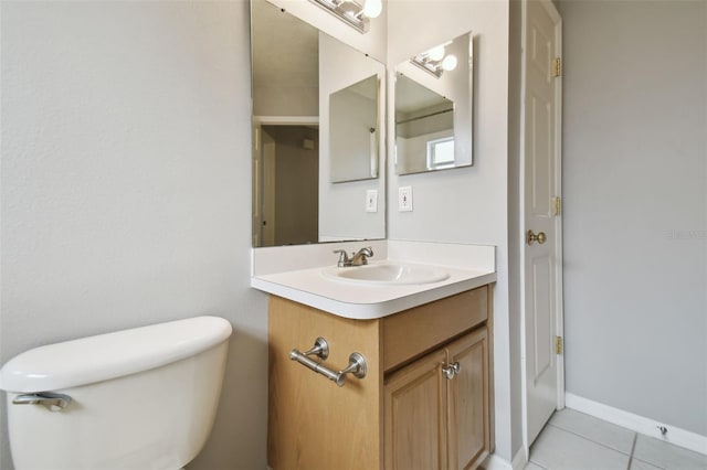 bathroom featuring vanity with extensive cabinet space, toilet, and tile floors