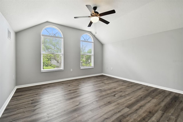 unfurnished room featuring a textured ceiling, dark wood-type flooring, ceiling fan, and vaulted ceiling