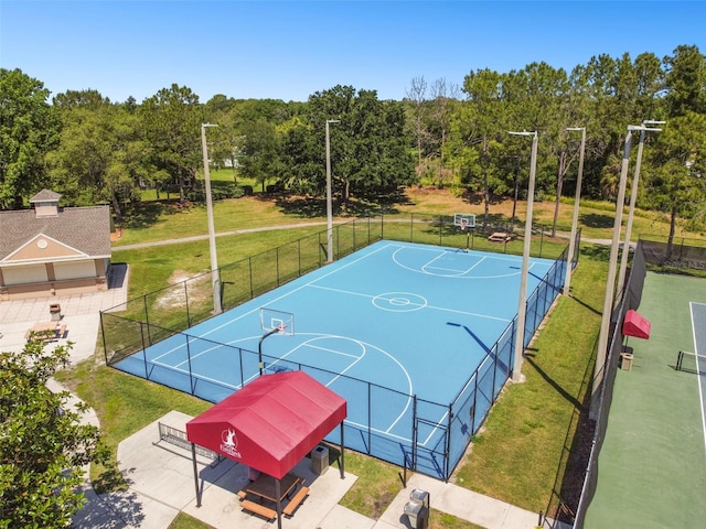 view of sport court featuring a yard