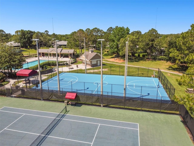 view of tennis court with basketball court and a fenced in pool