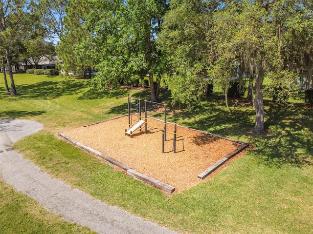 view of property's community featuring a yard and a playground