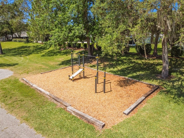 view of playground with a lawn