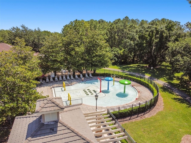 view of swimming pool with a yard