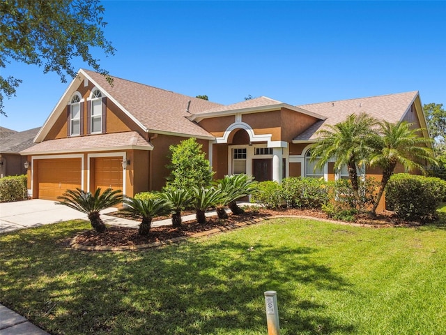 view of front of house with a garage and a front yard