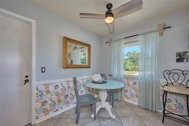 tiled dining space with ceiling fan