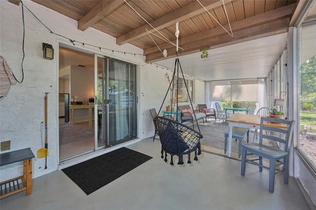 sunroom with wooden ceiling, beam ceiling, and plenty of natural light