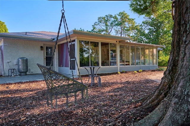 back of house featuring a patio area and a sunroom